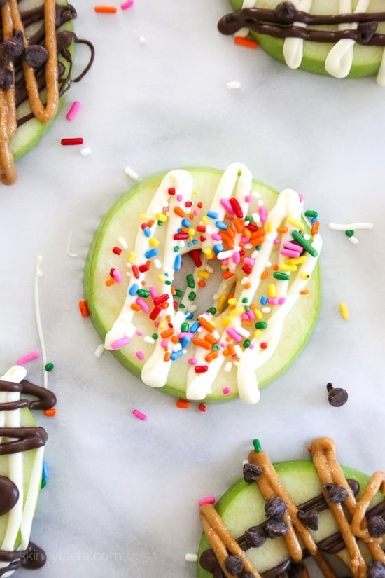 Apple slices shaped like donuts with chocolate drizzle