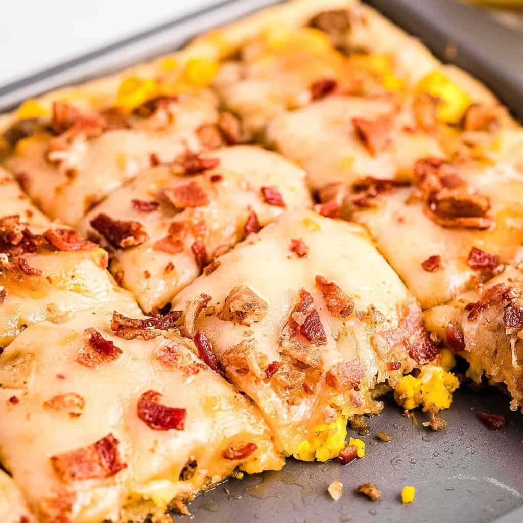Breakfast pizza with eggs, sausage, bacon and cheese