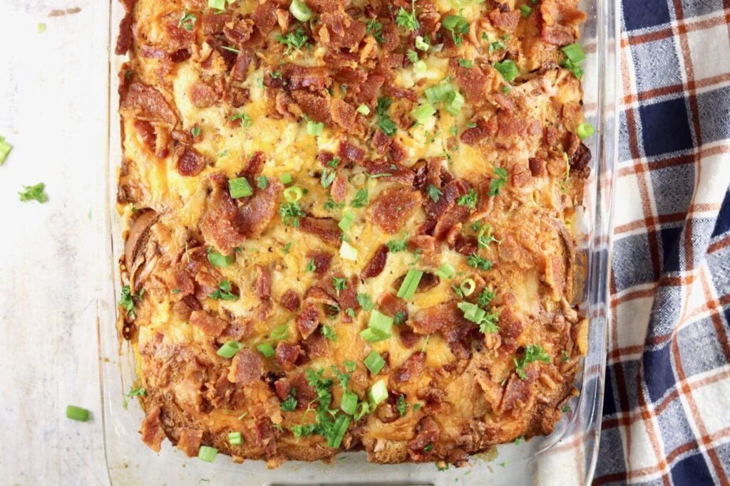 Ham and cheese breakfast strata topped with bacon