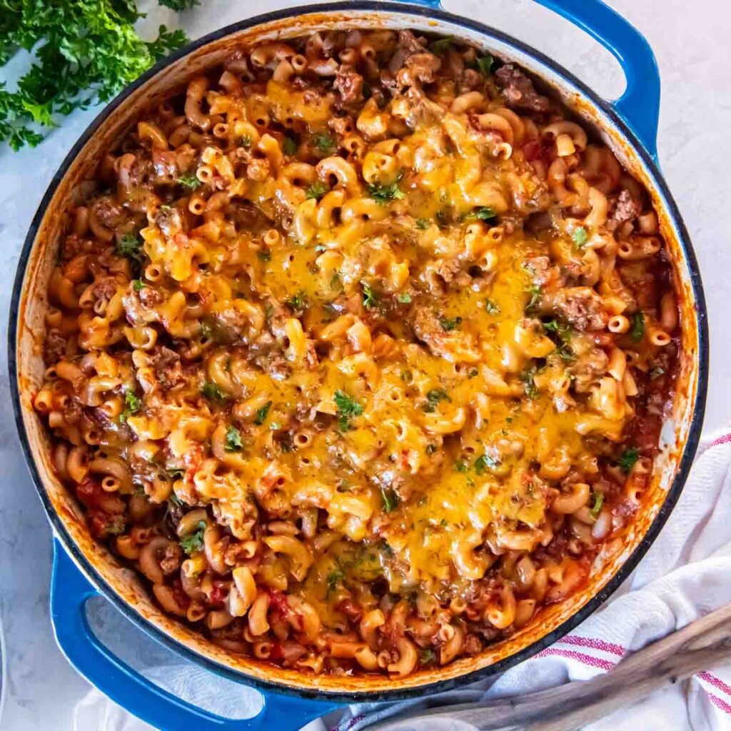 One pot ground beef pasta with melted cheddar in a skillet