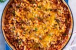 One pot ground beef pasta with melted cheddar in a skillet