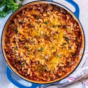 One pot ground beef pasta with melted cheddar in a skillet