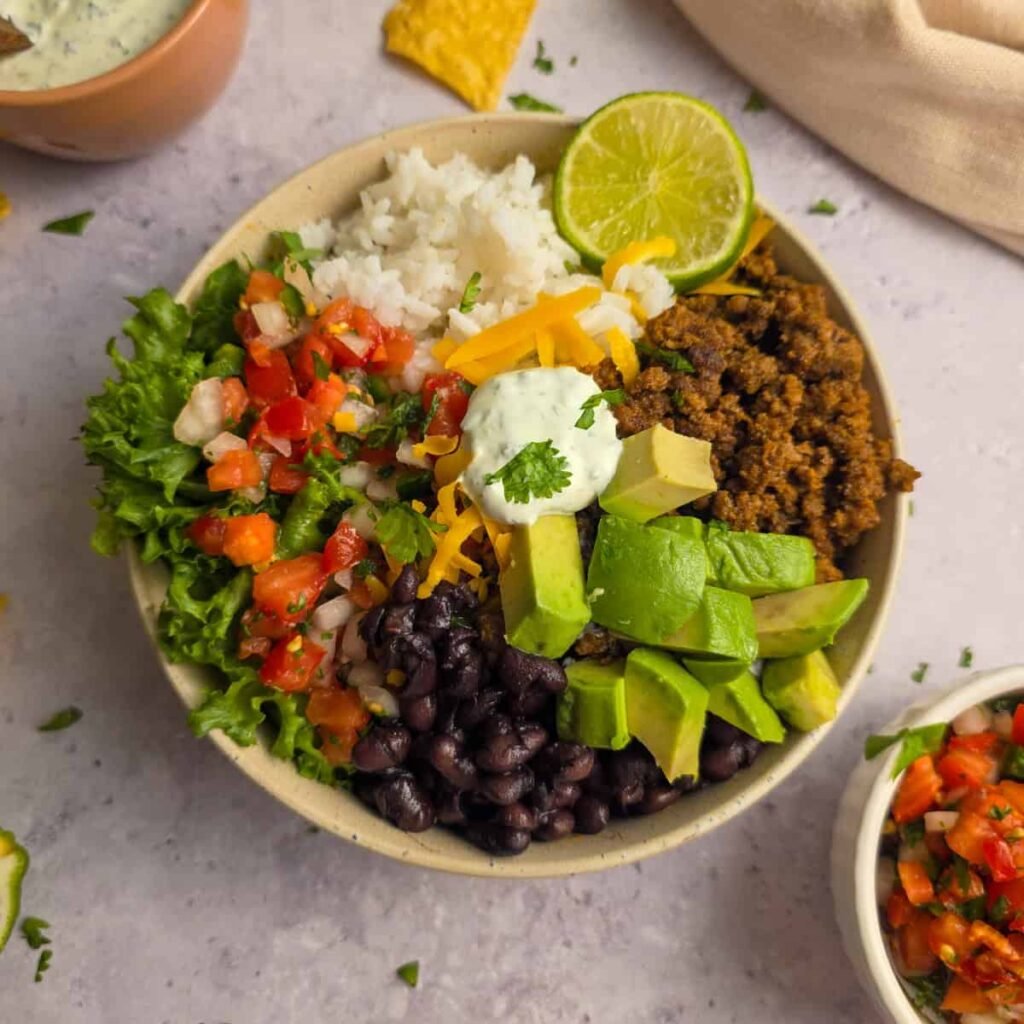 Ground beef taco bowl with rice, black beans and avocado