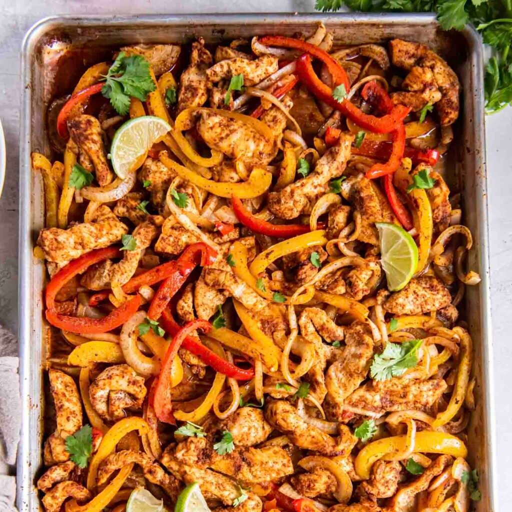 Sheet pan chicken fajitas with sliced bell peppers and onions